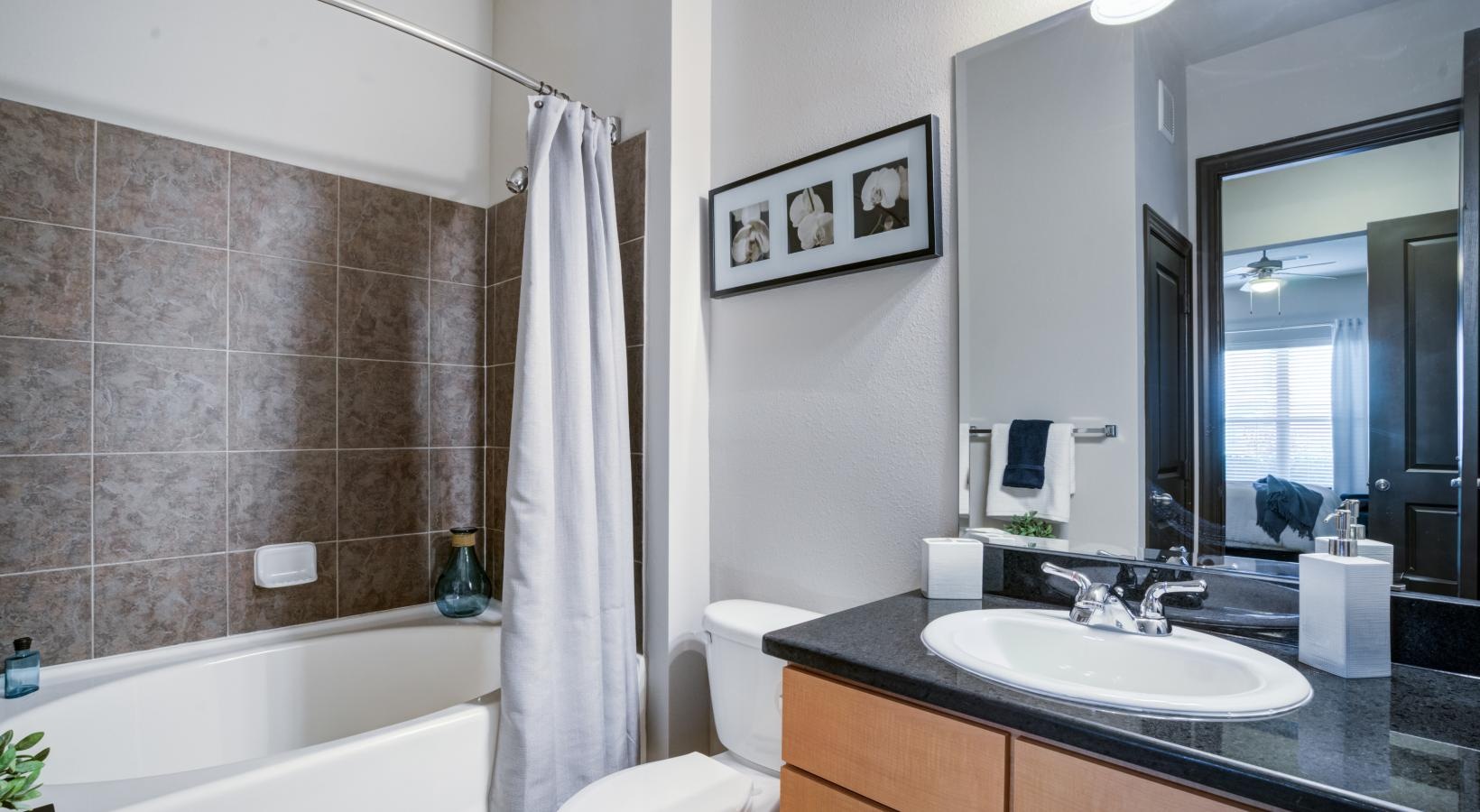 Bathroom options with thoughtful details a bathroom with a tub sink and toilet